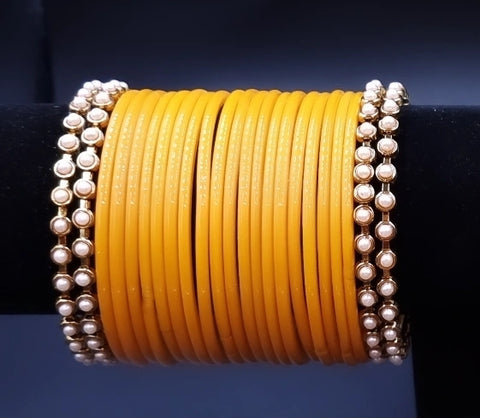 Designer yellow glass bangles with pearl metal bangles set. ( 2.8 )