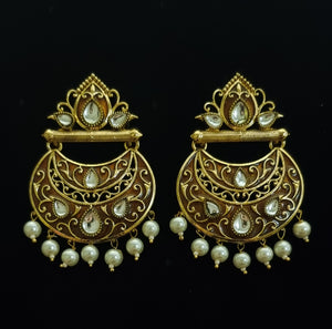 Traditional copper gold kundan and pearl earrings.