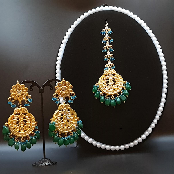 Bridal kundan piece is four layered set with dangling emeralds to match your festive.