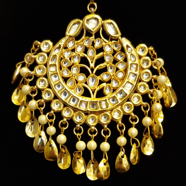 Kundan with golden pipal patti  earrings and tikka.