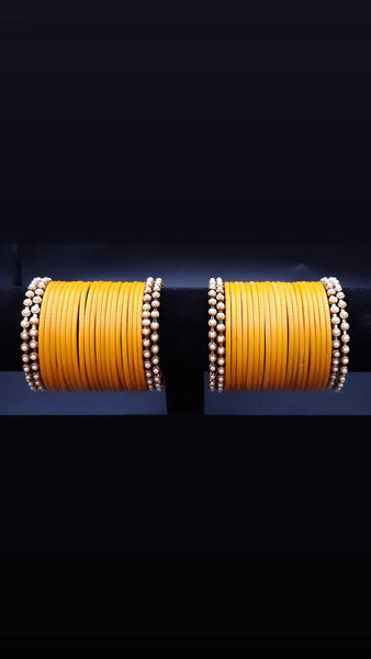 Designer yellow glass bangles with pearl metal bangles set. ( 2.8 )